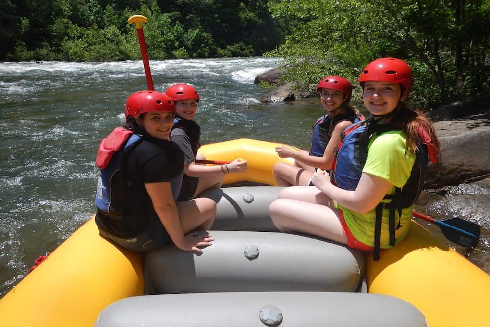 group of friends rafting with Quest
