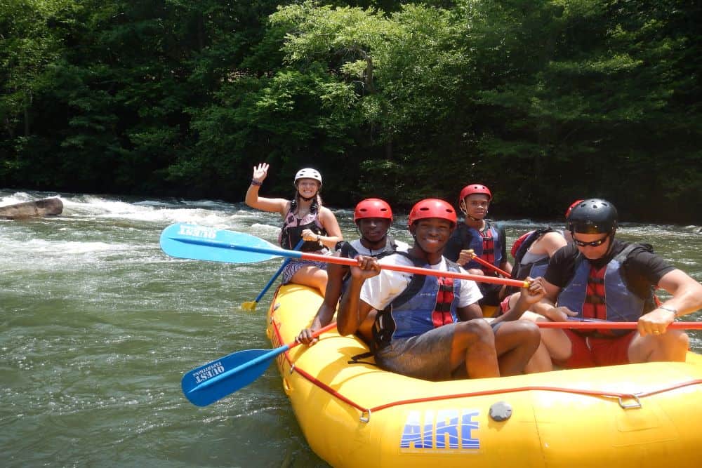 Guests pose for a photo during their white water rafting adventure with Quest Expeditions.