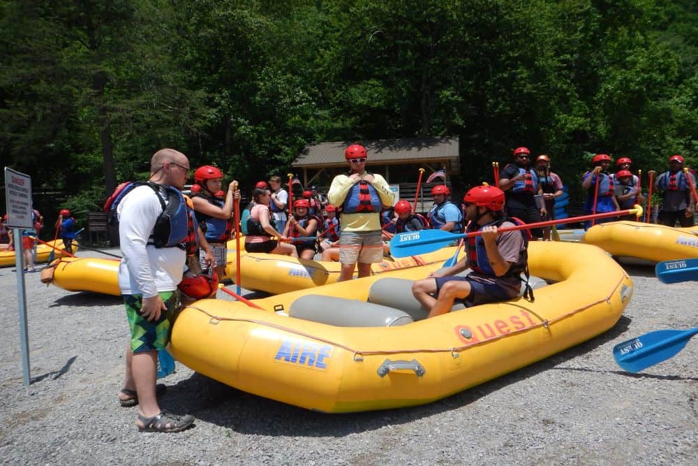 A group of rafts prepare to enter the river.